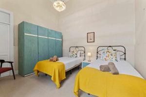 a bedroom with two beds and a green cabinet at Valls De Quintana Casa Emblemática Arrecife in Arrecife