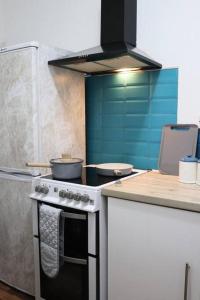 a kitchen with a stove with pots and pans on it at Peaceful 2 Bed House FREE WiFi and Parking in Belle Isle