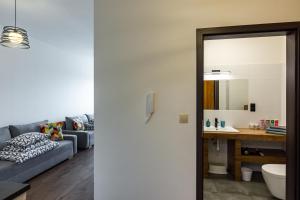 a living room with a couch and a table at ENERGYLANDIA Zator Apartament Madzia in Zator