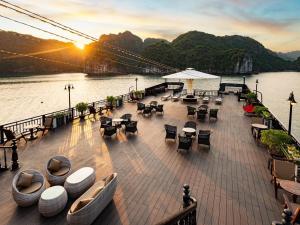 a deck of a cruise ship with tables and chairs at Eclipse Legend Hotel in Hanoi