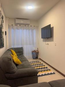 a living room with a couch and a flat screen tv at Mi casa es tu casa ! in Santa Cruz de la Sierra