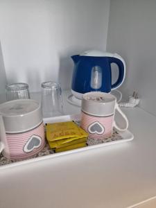 a shelf with two cups and a teapot at Apartments and Rooms Ski in Vlasic