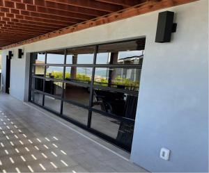 a building with large windows with a view of a bridge at Contemporary Ocean Sunset Views with Firepit Pt Loma close to PLNU in San Diego