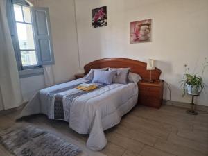 a bedroom with a bed and a table and a window at A Casa da Lúa in Nieves