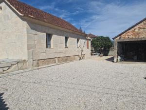 an outside view of a building with a gravel driveway at A Casa da Lúa in Nieves