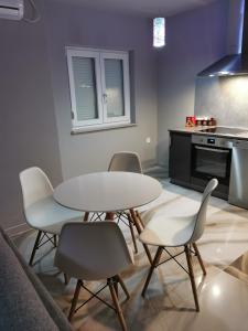 a kitchen with a table and chairs and a stove at Apartment Luki in Povile
