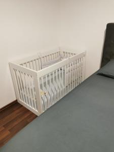 a crib in the corner of a room at Apartment Luki in Povile