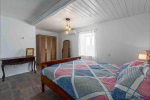 a bedroom with a bed and a piano at Villa Rosa Kringa in Tinjan +19 photos