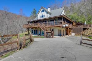 a large house with a porch and a wooden fence at Beautiful Bryson City Home with Hot Tub and Mtn Views! in Bryson City