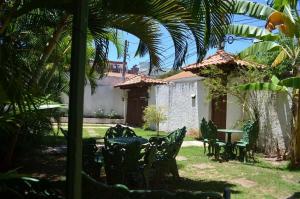 a yard with chairs and a table and a house at Grand Maison Du Fort in Škorak