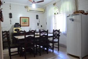 a dining room with a table and chairs and a refrigerator at Grand Maison Du Fort in Škorak