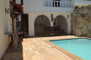 a large swimming pool in a building with a house at Grand Maison Du Fort in Škorak