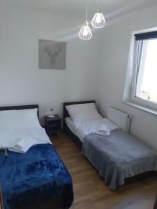 Postel nebo postele na pokoji v ubytování Apartament Zuza w Wiśle