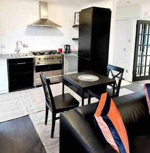 a kitchen with a couch and a table in a kitchen at Central London Apartment - Yvonné in London