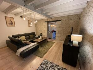 Saint-Michel-de-Fronsac的住宿－Le Petit Chai Fronsadais，客厅配有沙发和桌子