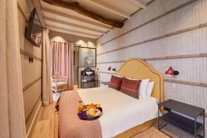 a bedroom with a bed with a bowl of food on it at THE PINTA Boutique Hotel in Armamar