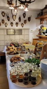 a buffet of food on a table in a kitchen at Gasthof zum Schiff in Obereisenheim
