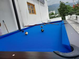 a blue pool table with balls on a balcony at Hotel Santa Fe del Parque in Santa Fe de Antioquia