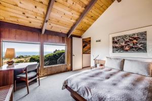 a bedroom with a bed and a desk and a window at The Glass House in Sea Ranch +34 photos