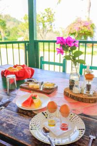 a wooden table with eggs and food on it at La Hacienda in San Gil