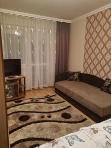 a living room with a couch and a rug at Katalin Apartman in Hajdúszoboszló