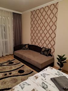 a living room with a couch and two beds at Katalin Apartman in Hajdúszoboszló