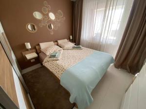 a small bedroom with a bed and a window at Lovely 1-bedroom apartament with free parking in Sofia
