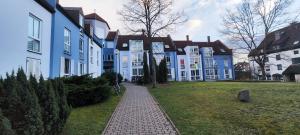 a row of blue and white buildings with a sidewalk at van Art Stucky in Bayreuth