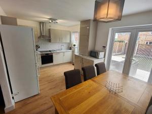 a kitchen and dining room with a table and chairs at 99 Stoney Bank Drive in Kiveton Park