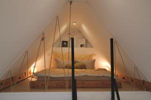 a bedroom with a canopy bed in a attic at Helles modernes City-Loft in Freudenstadt