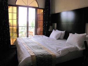 A bed or beds in a room at Stipp Hotel Gisenyi