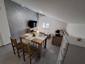 a kitchen and living room with a table and a couch at Apartments Sofie & Emily in Gornji Karin