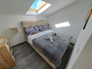 a bedroom with a bed with two slippers on it at Apartments Sofie & Emily in Gornji Karin