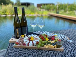 a tray of food and two glasses of wine on a table at Life Contains Beautiful Things in Almere