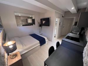 a hotel room with a bed and a desk and a sink at Center Beach Apartament, Split, Croatia in Split