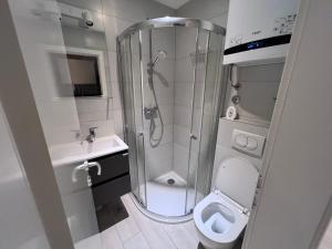 a bathroom with a shower and a toilet and a sink at Center Beach Apartament, Split, Croatia in Split