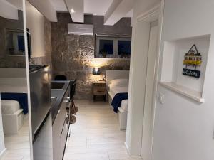 a room with a kitchen and a bedroom with a bed at Center Beach Apartament, Split, Croatia in Split