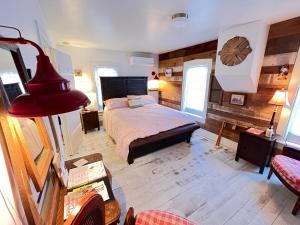 a bedroom with a bed and a red lamp at The FarmHouse Inn Bed and Breakfast in Nappanee