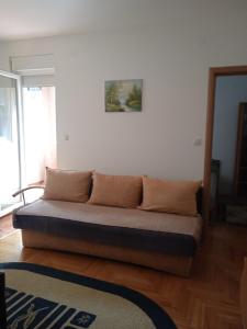 a couch sitting on the floor in a room at Benvenuto in Vrnjačka Banja