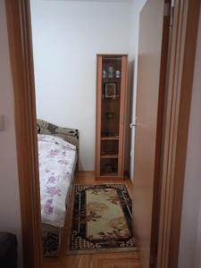 a room with a bedroom with a bed and a closet at Benvenuto in Vrnjačka Banja
