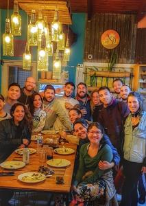 a group of people posing for a picture at a table at The Host Puerto Iguazú in Puerto Iguazú