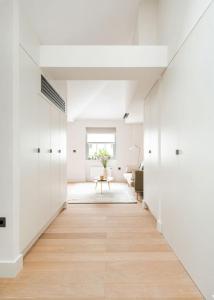 a hallway of a house with white walls and wood floors at Notting Hill Gate Residence VI in London