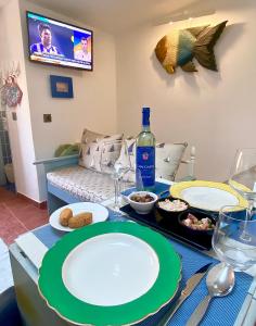 a table with plates of food and a bottle of wine at A Berlenga 3 in Nazaré +10 photos