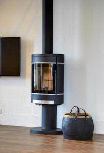 a black fireplace with a purse next to it at Loft 65 66 Panoramic View in Vilnius