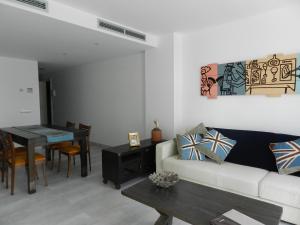 a living room with a couch and a table at Apartaments El Cine in Roses