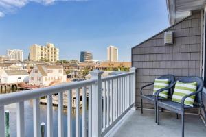 a balcony with two chairs and a view of the city at PERFECT 5 STAR - Chelsea Harbor House in Atlantic City