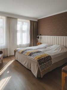 Postel nebo postele na pokoji v ubytování Grand Hotel Egersund