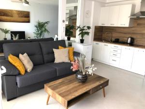 a living room with a couch and a coffee table at Apartament in Costa Adeje Playa de las Americas CasaNico in Playa de las Americas