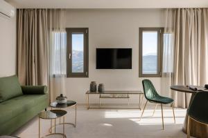 a living room with a green couch and chairs at Anthemis Living in Argostoli