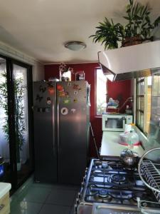 a kitchen with a refrigerator and a stove in it at Los Laguitos in Santiago